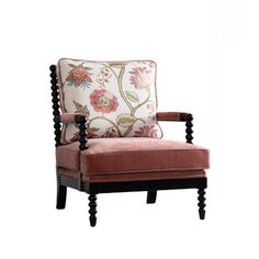 an upholstered chair with pink and white pillows