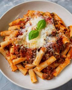 a white bowl filled with pasta and sauce