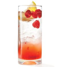 a tall glass filled with ice and raspberries