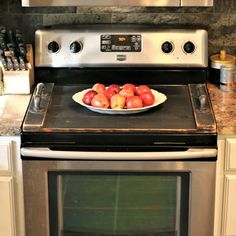 a bowl of apples is sitting on the stove