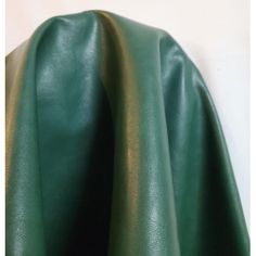 the green leather is folded up and ready to be used as a tablecloth or cover