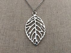 "Perfect for everyday wear, here is a beautiful and highly detailed silver leaf pendant necklace. It is timeless and sophisticated. Made from allergy free plated silver and hangs from a shiny and strong 18\" stainless steel necklace chain with a little lobster clasp. Leaf Pendant measures 1 7/8\" long by 1\" wide. I have matching earrings in my shop if you would like the whole set. https://www.etsy.com/listing/163035745/big-silver-leaf-earrings-statement Thanks for stopping by! Please take a mom Silver Leaf-shaped Nature-inspired Necklace, Silver Leaf-shaped Necklaces For Gift, Silver Leaf-shaped Necklace Gift, Silver Leaf-shaped Necklace For Gift, Handmade Silver Leaf-shaped Necklace, Silver Leaf-shaped Sterling Silver Necklace, Silver Leaf-shaped Necklace, Silver Leaf Jewelry For Jewelry Making, Silver Leaf-shaped Jewelry For Jewelry Making