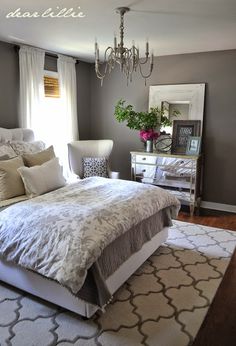 an instagramted photo of a bed in a bedroom with white and gray decor