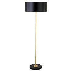 a black and gold floor lamp on a white background with a black shade over it