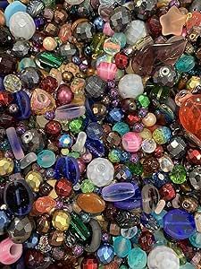 many different colored glass beads are scattered together