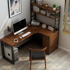 a computer desk with a monitor and keyboard on top of it next to a chair