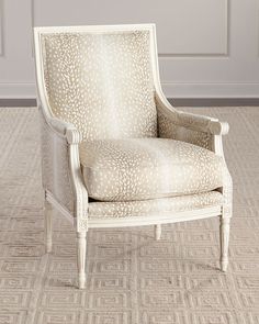 a white chair sitting on top of a carpeted floor next to a wall and door