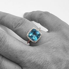 14KW Blue Topaz and Diamond Halo Ring.Size 7Weight Diamonds: 0.20cttwWeight Blue Topaz: 4.80CtColor Stone Shape: Cushion Cut