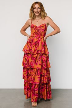 Vibrant maxi for fun occasions Orange base with pink leaf print Material has no stretch Sweetheart neckline Smocked back Adjustable spaghetti straps Fully lined until bottom tier Self and Lining: 100% Polyester Marianne is 5'6, cup size 34D, size 6 and wearing size S Pink And Orange Bridesmaid Dresses, Orange Bridesmaid Dresses, Ginger Dress, Pink Leaves, Tiered Maxi Dress, Vibrant Orange, Cup Size, Leaf Print, Leaf Prints