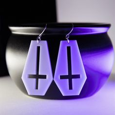 These pastel coffin earrings are laser cut from an opaque lilac acrylic and have an inverted cross cutout in the middle. They measure 1 and 3/4 inches long and hang from nickle free earring hooks. If you love this design but would like the whole thing turned upside-down please send me a message! This design can also be cut from any of the other colors you see in my shop. SHIPPING All items purchased will be shipped within two business days through USPS. Just choose the shipping option that's rig Coffin Earrings, Cross Cutout, Cross Gothic, Inverted Cross, Laser Cut Acrylic, Free Earrings, Purple Lilac, Earring Hooks, Acrylic Earrings