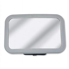 a mirror that is sitting on top of a white surface with a reflection in it