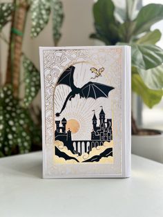 a card with an image of a bat flying over a castle