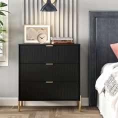 a bedroom scene with focus on the chest of drawers and wall decor, along with a bed