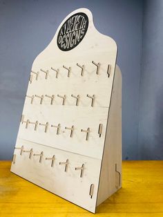 a wooden board with several pegs attached to it and the word world design on top