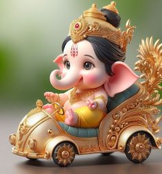 an elephant figurine sitting on top of a gold car with a crown on it's head