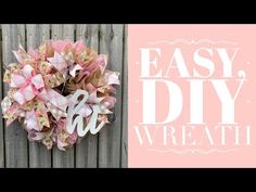 a pink and white wreath with the words easy diy wreath on it next to a wooden fence