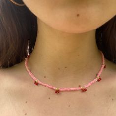 Introducing our sweet and playful pink beaded choker, featuring adorable cherries all around! Handcrafted with love, this choker is the perfect accessory for anyone who loves to add a touch of whimsy to their outfit. The choker features a delicate beaded design in shades of pink, with alternating beaded bright red cherries with green stems creating a charming and delightful look. This choker is also incredibly comfortable to wear, with a soft and lightweight construction that won't weigh you down. Whether you're dressing up for a summer picnic or adding a playful touch to your everyday look, this beaded choker is sure to turn heads and make a statement. Perfect for those who love kitschy and cute accessories, this choker is a must-have for any fashion-forward individual. It also makes a wo Cherry Beaded Necklace Tutorial, Pink Choker With Tiny Beads For Summer, Summer Pink Choker With Tiny Beads, Trendy Pink Choker With Tiny Beads, Trendy Pink Beaded Choker Necklaces, Trendy Pink Tiny Beads Choker, Y2k Pink Beaded Necklaces, Trendy Pink Choker With Round Beads, Pink Beaded Dainty Choker