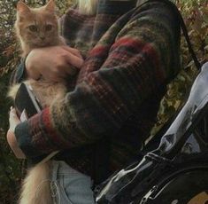 a woman holding a cat in her arms