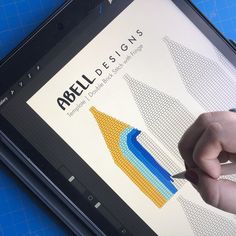 a person is drawing on the screen of a tablet with an arrow in front of it