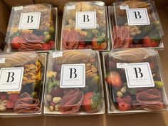 four boxes filled with assorted fruits and nuts in each one's own letter