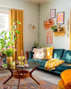 a living room filled with lots of furniture and colorful decorations on the wall above it