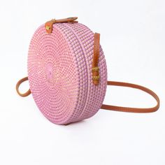 The Ata Bali is the must-have crossbody bag for all of your warm-weather events - from vacations to beach days. Keep your belongings secure with the Snap closure and the beautiful fabric-lined interior. Wipe Clean / Rattan Pink Shoulder Bag For Summer, Pink Crossbody Shoulder Bag For Vacation, Pink Summer Shoulder Bag With Adjustable Strap, Summer Pink Shoulder Bag With Adjustable Strap, Pink Crossbody Shoulder Bag For Beach, Pink Straw Bag For Daily Use In Summer, Purple Summer Vacation Bags, Spring Travel Pink Straw Bag, Pink Shoulder Beach Bag With Adjustable Strap