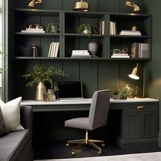 a home office with green walls and gold accents on the shelves, along with a gray couch