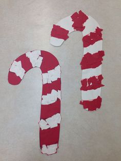 a red and white candy cane made out of torn paper