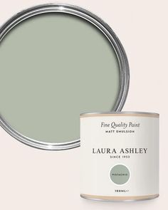 a green paint can with the words,'fine quality paint'in white lettering