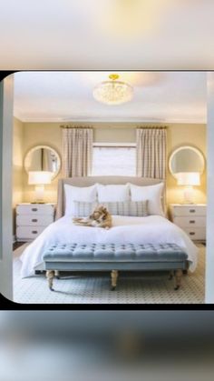 a dog laying on top of a white bed in a room with beige walls and curtains