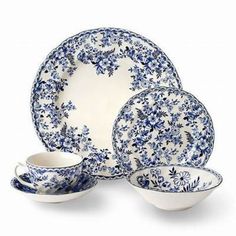 blue and white china dinnerware set with flowers on the rim, bowl and saucer