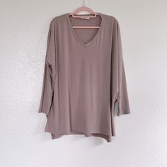 This Mocha V-Neck Top Has Dolman Style Sleeves With Small Side Slits, And A Loose Fit. The Material Is A Soft Polyester/Rayon/Spandex Blend With Great Stretch, And It’s New Without Tags From A Boutique. It Measures About 31” From Underarm To Underarm And About 31” In Length. C2 Taupe V-neck Top For Fall, Chic Taupe V-neck Top, V-neck Blouse For Layering, Taupe V-neck Summer Tops, Fall Taupe V-neck Top, V Neck Tops, Tunic Top, Mocha, Tunic Tops