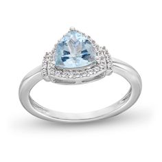 an aqua blue topazte and diamond ring with white diamonds on the sides, set in