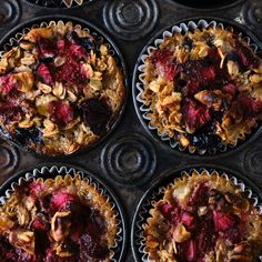 four muffin tins filled with different types of fruit and toppings on top of each other