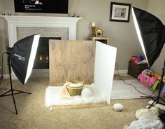 a photo studio with lighting equipment in front of a fireplace