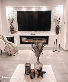 a living room filled with furniture and a flat screen tv mounted on the wall above a fireplace