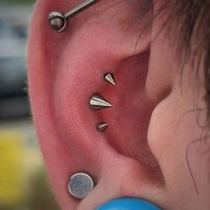 an ear with three different piercings on it