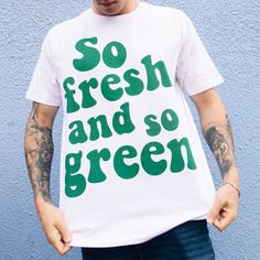 Super fresh.  Printed t-shirt by Batch1 Slogan to front: "So Fresh And So Green" in 70s style typography Print: Organic, water-based, eco-friendly ink Style: Crew neck, short sleeves, soft jersey Fit: Relaxed, Unisex Size Guide (chest to fit):  S - 34/36" | M - 38/40" | L - 42/44" | XL - 46/48" | XXL - 50/52" Model wears size Extra Large  Material: 100% organic cotton Sustainability: Ethically made to order in the UK  | Global Organic Textile Standard | Fair Wear | Vegan  Care: Machine wash Cheap Green Graffiti Print T-shirt, Cheap Green T-shirt With Graffiti Print, Eco-friendly Green Cotton T-shirt, Unisex Green Screen Print T-shirt, Unisex Retro T-shirt With Text Print, Retro Green T-shirt For Streetwear, Organic Short Sleeve T-shirt With Screen Print, Earth Day Graphic Tee With Letter Print, White T-shirt With Earth Day Graphic Print