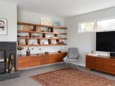 a living room with a fireplace and entertainment center