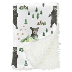 a blanket with bears and trees on it