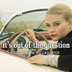 a woman leaning on the steering wheel of a car