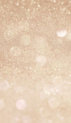 a blurry background with lots of small white dots on it's edges and light pink hues