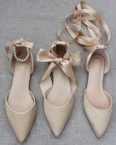 three pairs of women's shoes with bows and pearls on the heel, all in beige