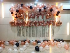 balloons and streamers decorate the entrance to an anniversary party