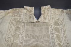 an old piece of cloth with some sort of design on the front and back side