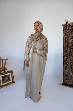 Drape yourself in timeless liquid gold this Ramadan. The soft sheen and even softer lightweight fabric will make you feel like you’re glowing. Complete the look with our black or beige layering dress or rock it alone. Pairs with Celestial Floral Sand Noor 5’4 S/M Standard (was wearing flats Wasiba 4’11 2XL/3XL Short (was wearing 1 inch platforms) Aissatou 5’9 L/XL Tall (was wearing flats) Available in a range of sizes and lengths that include sizes 2 to 16. SIZE/FIT Muslimah Makeup, 2025 Rebrand, Abaya Aesthetic, Celestial Floral, Gold Henna, Hijab Colors, Modest Clothes, Eid Outfits, Hijabi Outfits