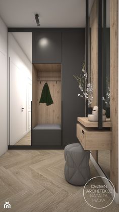 an empty room with a wooden floor and some plants in vases on the table