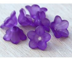 small purple flowers sitting on top of a wooden table