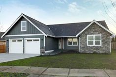 a gray and white house with two garages