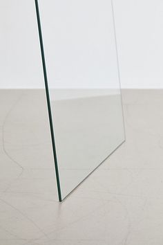 a mirror sitting on top of a white floor